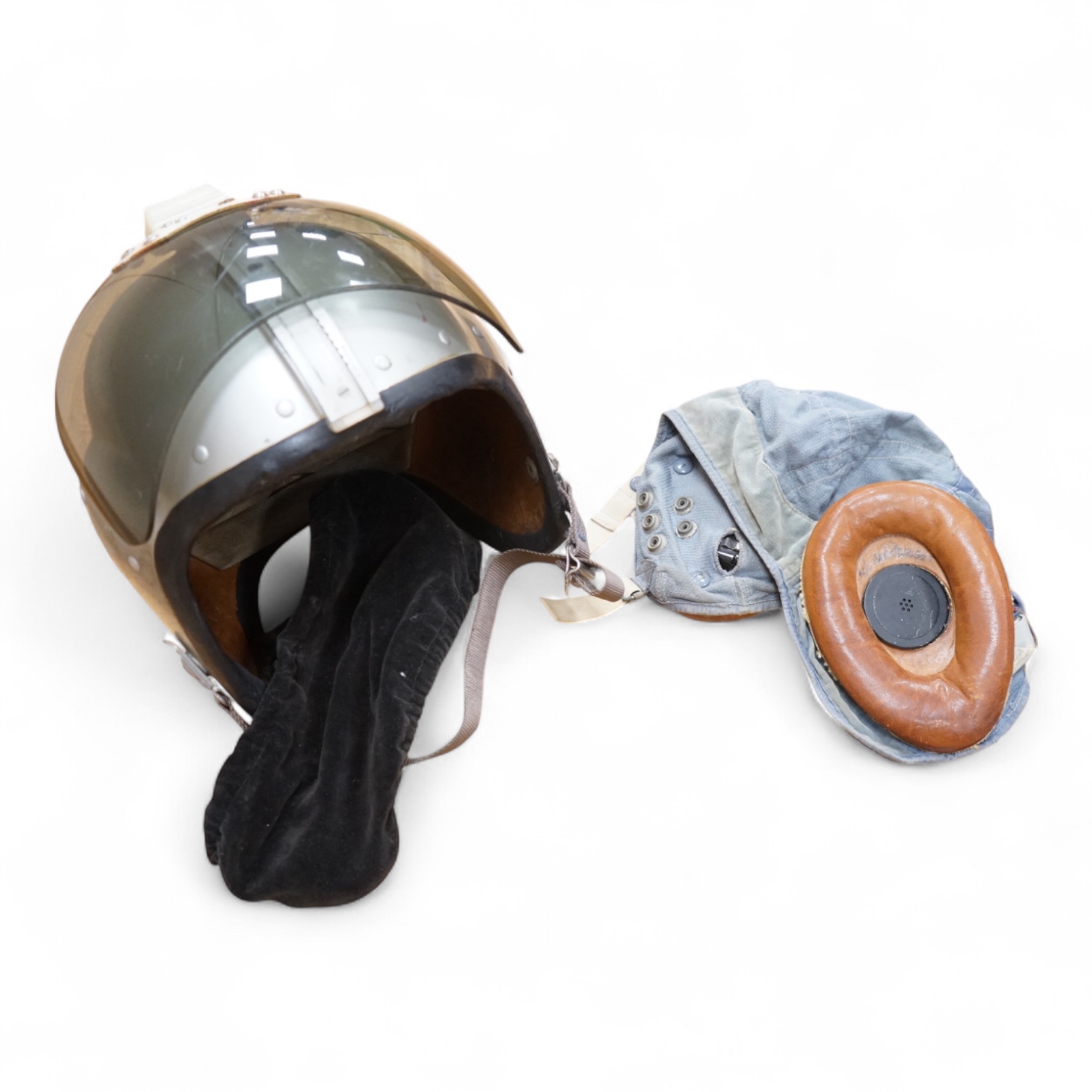 An early British jet aircraft RAF flying helmet, size 3 regular, dated 1958, with visor and visor cover, and original interior webbing, complete with inner cloth flight cap with built-in headphones and electrics and date